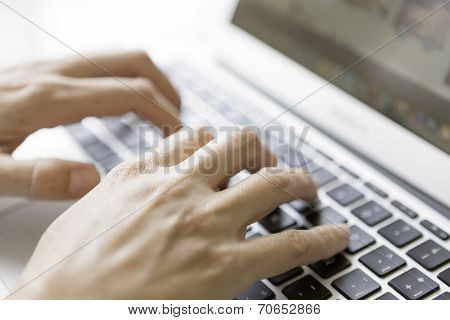 Hands Typing On Laptop Keyboard