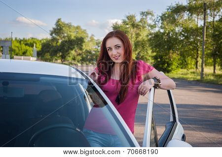 Beautiful smiling redhead woman traveling by car