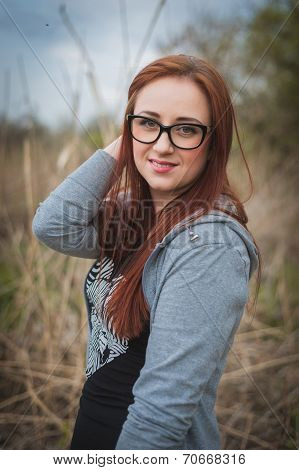 Young woman with glasses in the field