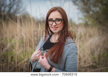 Young woman with glasses in the field
