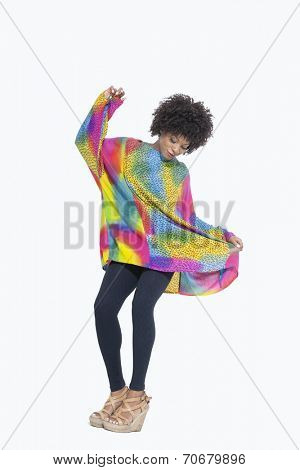 Full length of an African American woman in dashiki over gray background