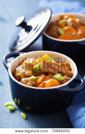 beef stew with potato and carrot in blue pot 