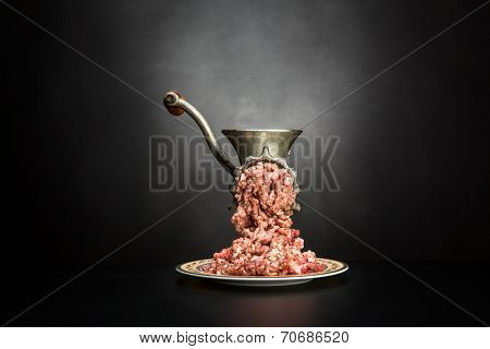 Meat grinder on a black background