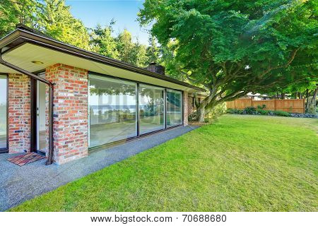 Beautiful Brick House With Glass Walls. Backyard View
