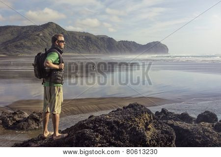 Backpacker looking at beautiful ocean view