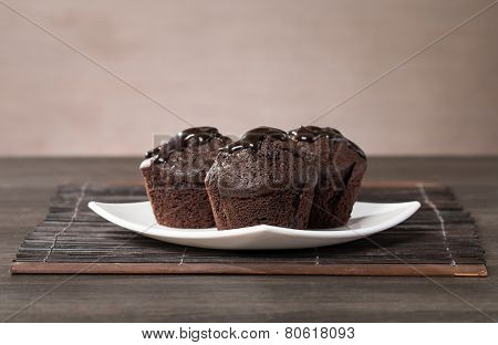 Spongecake Or Muffin With Chocolate Sauce