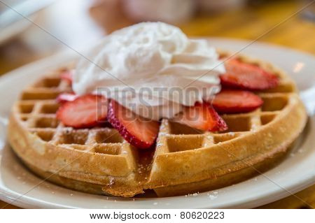 Waffle Topped With Strawberries And Whipped Cream