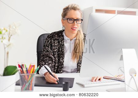 Female designer working with computer
