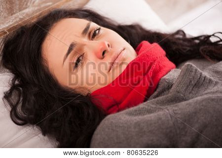 Young sick girl lying in bed