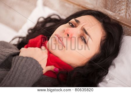 Young sick girl lying in bed