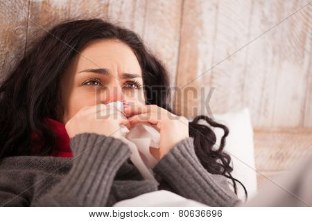 Young sick girl lying in bed