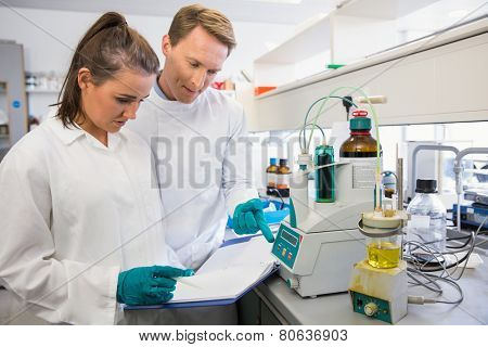 Young scientists conducting an experiment together at the laboratory