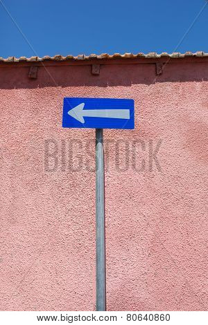 One-way traffic road sign. White arrow on blue background