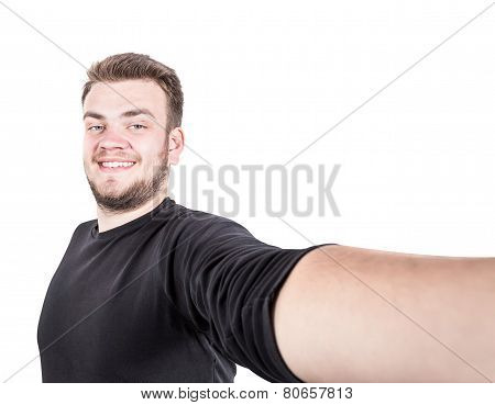 Happy young man taking a selfie photo. Isolated on white background