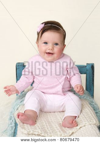 Happy Baby Sitting On Bed