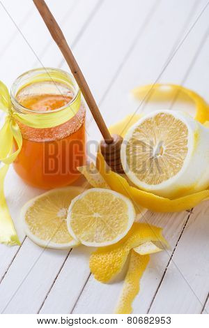Honey In Glass Jar And Lemons