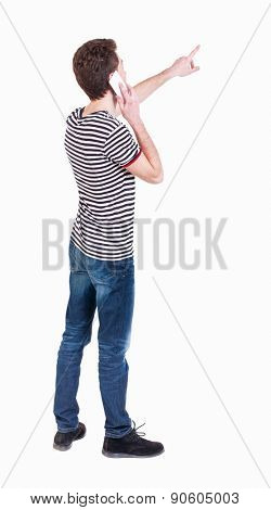 Back view of  pointing young men talking on cell phone. Young guy  gesture. Rear view people collection. backside view of person.  Isolated over white background. Curly guy on phone tells what he saw 