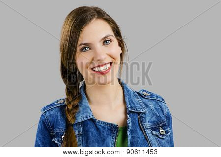 Portrait of a eautiful woman smiling over a grey background 