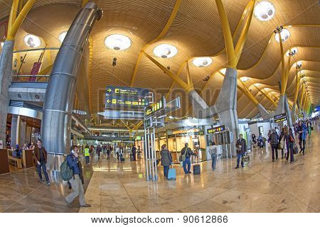 Passengers Walk By At The New Terminal T4 At Barajas Airport On April 1,2012 In Madrid. This Additio