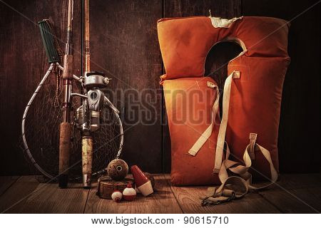 Vintage still life fishing poles and life jacket