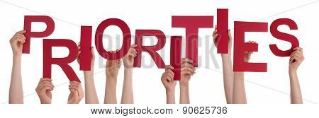 Many People Hands Holding Red Word Priorities