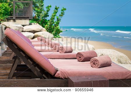 Empty Sunbed With Wrapped Towels On A Beautiful Beach On Sunny Day