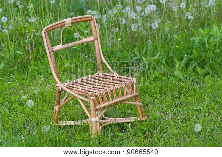Wicker chair for kids in spring grass