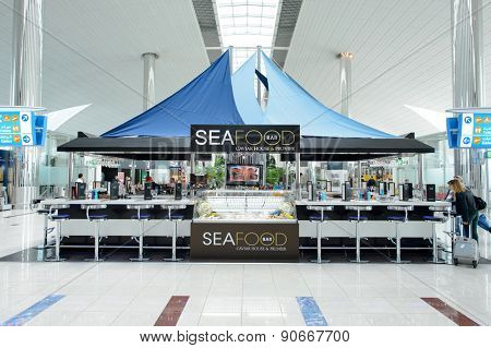 DUBAI, UAE - MARCH 10, 2015: DXB airport interior. Dubai International Airport is the primary airport serving Dubai, and is the world's busiest airport by international passenger traffic.