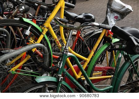 AMSTERDAM, NETHERLANDS - AUGUST 9, 2012: Colourful bicycles parked at the bicycle parking station next to the Central railway station in Amsterdam, Netherlands.