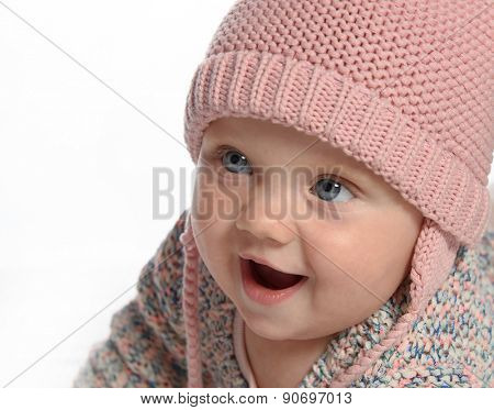 baby girl child  smiling happy pink fashion portrait face studio shot isolated on white caucasian hat warm clothing