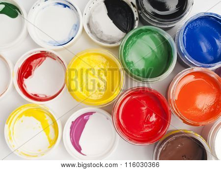 Paint buckets in soft focus on a white background.