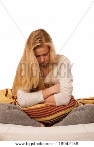 Woman Sitting On Bed Holding Belly Because Of The Pain In Stomac.