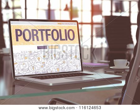 Portfolio on Laptop in Modern Workplace Background.