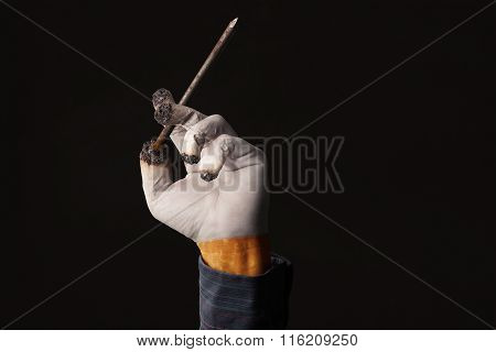 Male Hand Holds A Coffin Nail Like A Cigarette