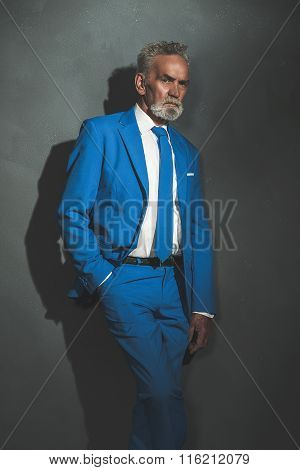 Middle Aged Businessman Leaning Against The Wall