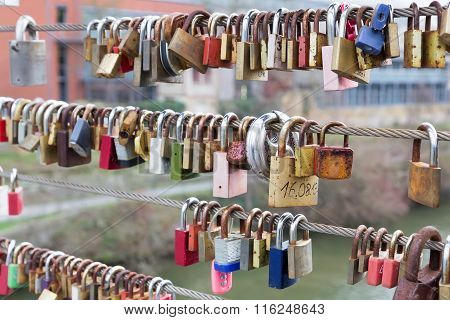 Love Padlocks Hanging From Railing On Bridge