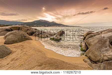 Rocks And Sand At Algajola Beach In Corsica
