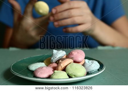Boy Hands With Macaron Cookies Close Up