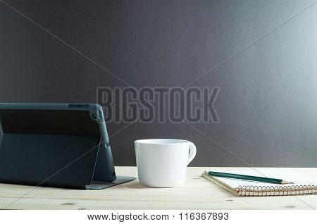 Workplace With Tablet And Coffee  On Wooden Desk.