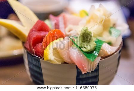 a chirashi - raw fish over rice bowl.