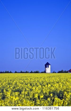 Water Tower In Beautiful Landscape With Blue Sky