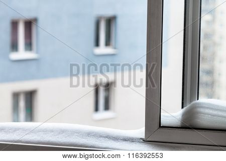 Snow On Home Window Casement And House In Winter