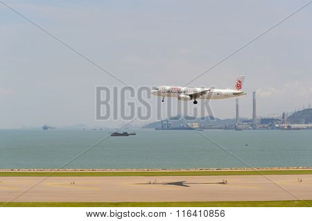 HONG KONG - JUNE 04, 2015: Dragonair aircraft landing at Hong Kong airport. Dragonair is a Hong Kong-based international regional airline