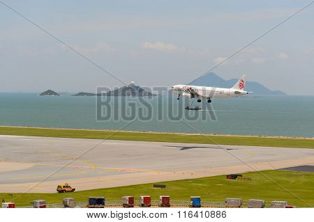 HONG KONG - JUNE 04, 2015: Dragonair aircraft landing at Hong Kong airport. Dragonair is a Hong Kong-based international regional airline