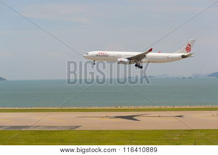 HONG KONG - JUNE 04, 2015: Dragonair aircraft landing at Hong Kong airport. Dragonair is a Hong Kong-based international regional airline