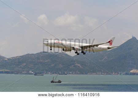 HONG KONG - JUNE 04, 2015: Dragonair aircraft landing at Hong Kong airport. Dragonair is a Hong Kong-based international regional airline