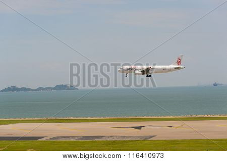 HONG KONG - JUNE 04, 2015: Dragonair aircraft landing at Hong Kong airport. Dragonair is a Hong Kong-based international regional airline