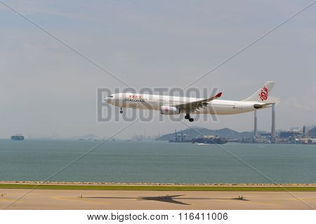 HONG KONG - JUNE 04, 2015: Dragonair aircraft landing at Hong Kong airport. Dragonair is a Hong Kong-based international regional airline