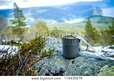 Travel titanium cup. Lunch during the journey to the wild. Camping lifestyle.