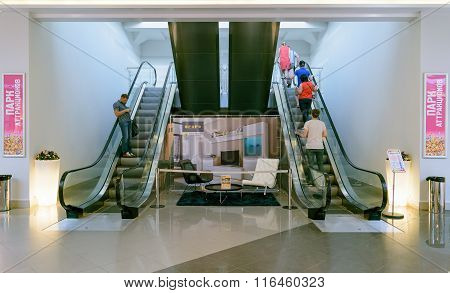 People Climb And Descend On The Escalator In Shopping Center Auchan